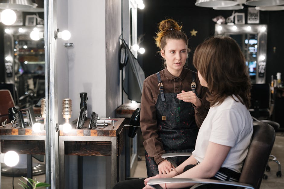 Hair stylist providing consultation to client in a modern salon setting